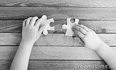 Cropped image of hands connecting two puzzle pieces Stock Photo