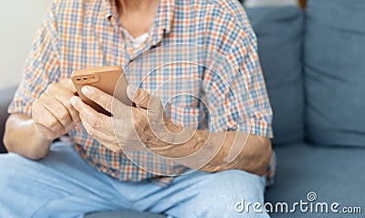 Cropped image of hands of older man holding a smart phone. Modern wireless technology easy usage of older Stock Photo