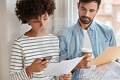 Cropped image of interracial colleague collaborate for presenting information for business partners, do paper work Stock Photo