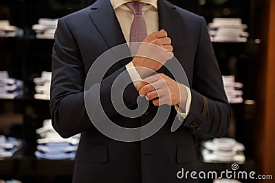 Cropped image of Man buttons up his shirt Stock Photo