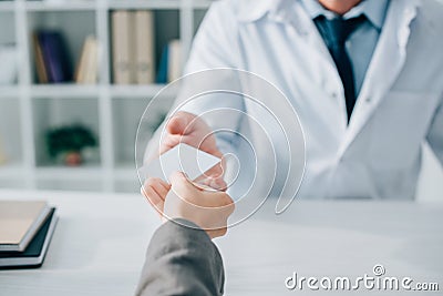 cropped image of patient giving id card to general practitioner Stock Photo