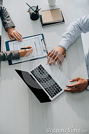 cropped image of patient signing insurance claim form in clinic doctor Stock Photo