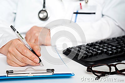 Cropped image of a physician writing prescription Stock Photo