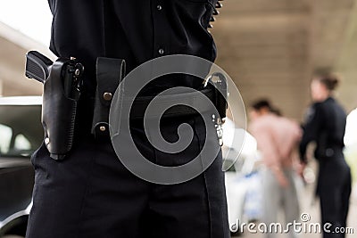 cropped image of policeman belt with gun Stock Photo