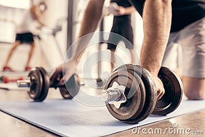 cropped image of sportsman preparing doing push ups on dumbbells Stock Photo