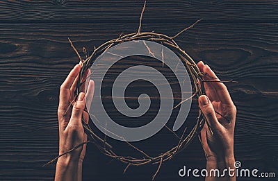 cropped image of woman holding crown of thorns Stock Photo