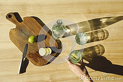 cropped image of woman putting glass with lemonade Stock Photo