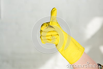 cropped image of woman in rubber glove showing thumb up while cleaning Stock Photo