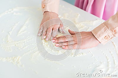cropped image of woman spreading flour Stock Photo