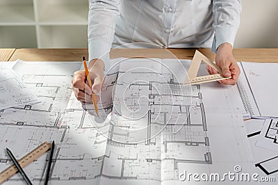 Cropped lady in her formalwear shirt she stand at the table hold tool instrument in hands create new space in interior building Stock Photo