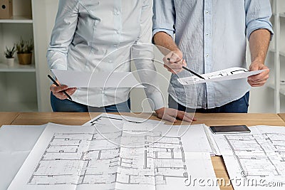 Cropped photo group of two person in formalwear shirt stand at the table in light loft interior workplace make modern renovation Stock Photo