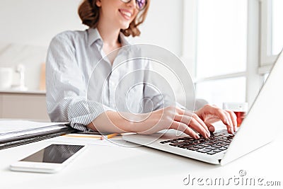 Cropped photo of pretty brunette woman typing email on laptop co Stock Photo