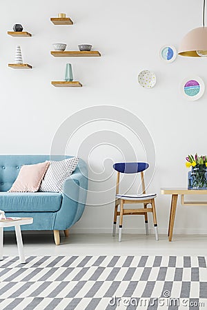 Cropped photo of a sofa, wooden chair, table, striped carpet and Stock Photo