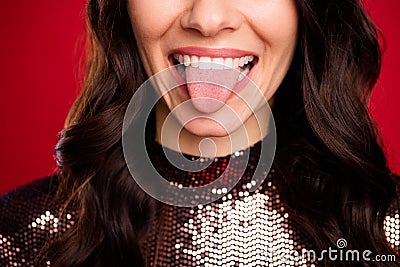 Cropped photo of young girl shiny white smile stick tongue out wear glossy shirt isolated red color background Stock Photo