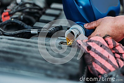 Automechanic changing motor oil Stock Photo