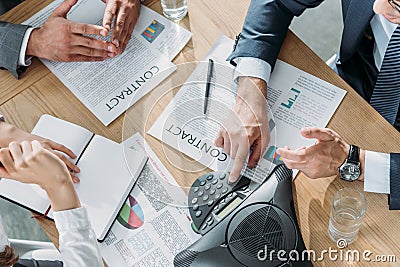 cropped shot of business people having conversation with contracts and speakerphone on table Stock Photo