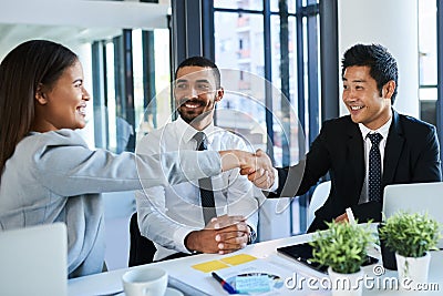 Partnering up to achieve success. Cropped shot of corporate businesspeople shaking hands in the workplace. Stock Photo