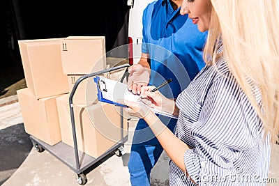 Woman signing delivery document Stock Photo