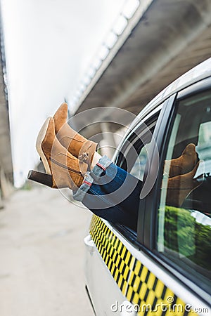 cropped shot of female legs in stylish shoes in open window Stock Photo