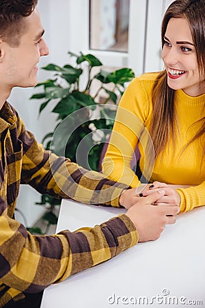 Cropped shot of funny boy and girl spending time in cafe, joking and laughing desparately. Stock Photo
