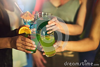 Cheers ladies Heres to us. Cropped shot of a group of women toasting with cocktails at a party. Stock Photo