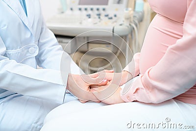 cropped shot of obstetrician gynecologist holding hands of pregnant woman Stock Photo