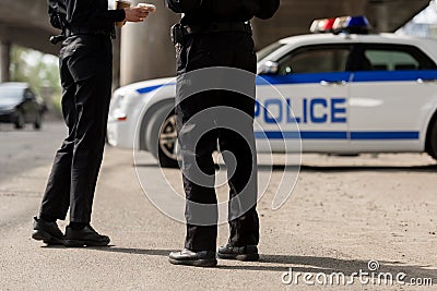 cropped shot of police officers standing in front of Stock Photo