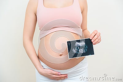 cropped shot of pregnant woman with ultrasound scan picture of baby Stock Photo