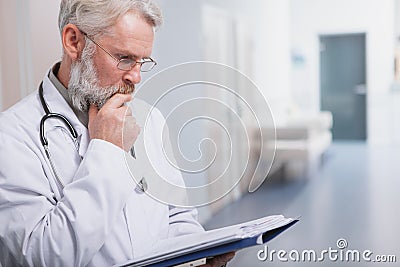 Elderly male doctor at his clinic Stock Photo