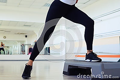 Cropped shot of skinny woman legs doing step aerobics Stock Photo