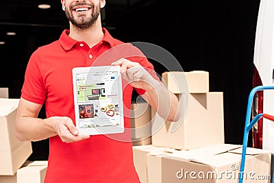 cropped shot of smiling delivery man Editorial Stock Photo