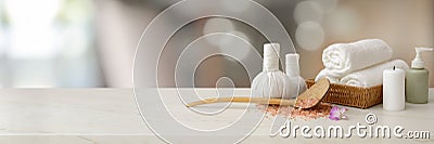 Cropped shot of Spa accessories with white towel, candle, aroma oil, herbal compressing balls Stock Photo
