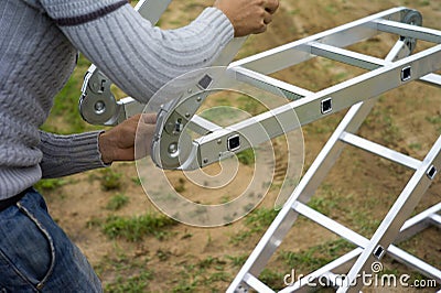 Worker arranging expandable ladder Stock Photo