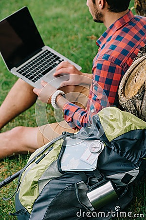 cropped shot of young male traveler using laptop Stock Photo