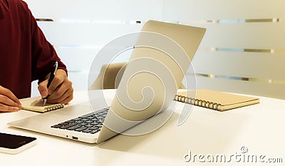 Cropped shot of a young man working from home using laptop Stock Photo