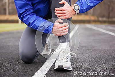 Cropped shot of a young runner holding his leg in pain. Stock Photo