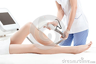 Cropped shot of young woman receiving laser skin care on leg Stock Photo