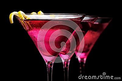 Cropped three cosmopolitan cocktails in line on black background Stock Photo