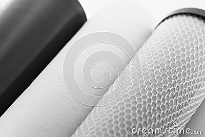 Cropped three filter cartridges for house water filtration system isolated. Foamed polypropylene, granular and Stock Photo