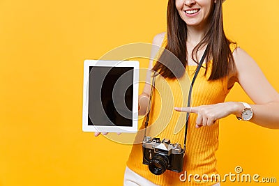 Cropped tourist woman holding tablet pc computer with blank black empty screen isolated on yellow orange background Stock Photo