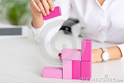 Cropped view of businesswoman stacking pink Stock Photo