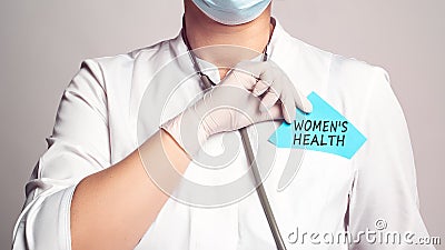 Cropped view of doctor in a white coat and sterile gloves holding a note with text - WOMEN`S HEALTH Stock Photo