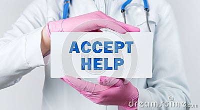 Cropped view of female doctor in a white coat and pink sterile gloves holding a card with words - Accept Help Stock Photo