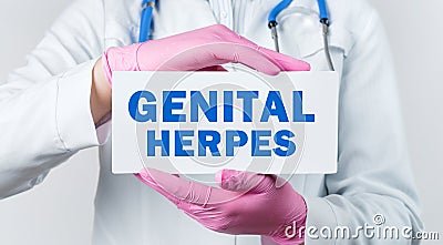 Cropped view of female doctor in a white coat and pink sterile gloves holding a card with words - GENITAL HERPES Stock Photo