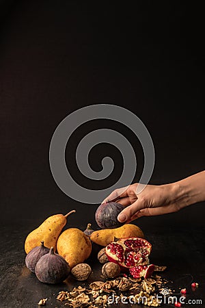 cropped view of hand with organic autumnal fruits Stock Photo