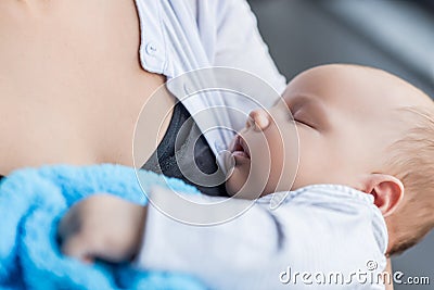 cropped view of mother holding her sleeping infant child Stock Photo