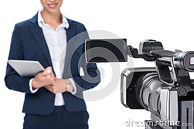 cropped view of newscaster with digital tablet standing in front of camera, Stock Photo