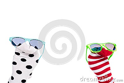 Cropped view of person with colorful sock puppets and sunglasses on hands Isolated On White. Stock Photo