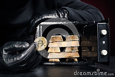 Cropped view of thief stealing gold bullions and bitcoin Editorial Stock Photo