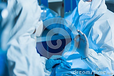 cropped view of virologist in hazmat Stock Photo